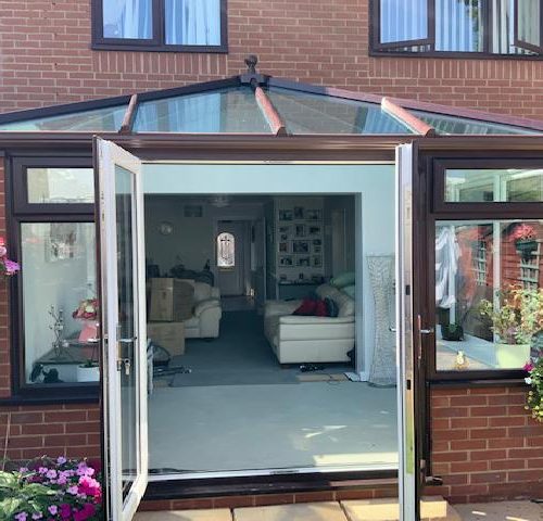 Brown conservatory with open doors
