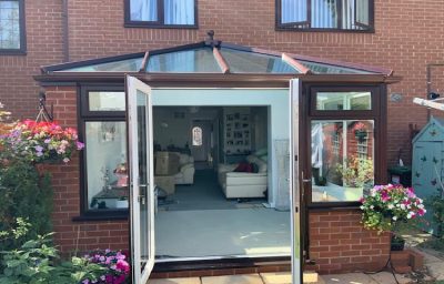 Brown conservatory with open doors